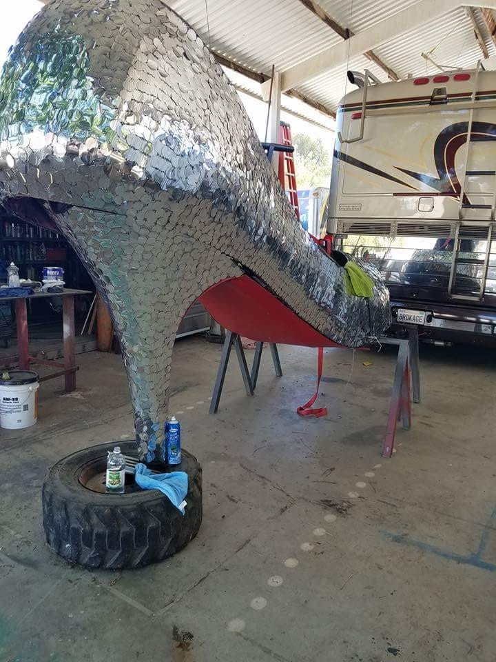 A behind the scenes look, as the Rainbow RV group prepares the Priscilla Pride float for San Diego California Pride Parade for this weekend's pride Parade. The shoe is lowered from its barn rafter housing and lowered as members, stitch any loose sequins, polish and shine and loop prepare it for its trip before its .outed on top the Rainbow RV Bus.
